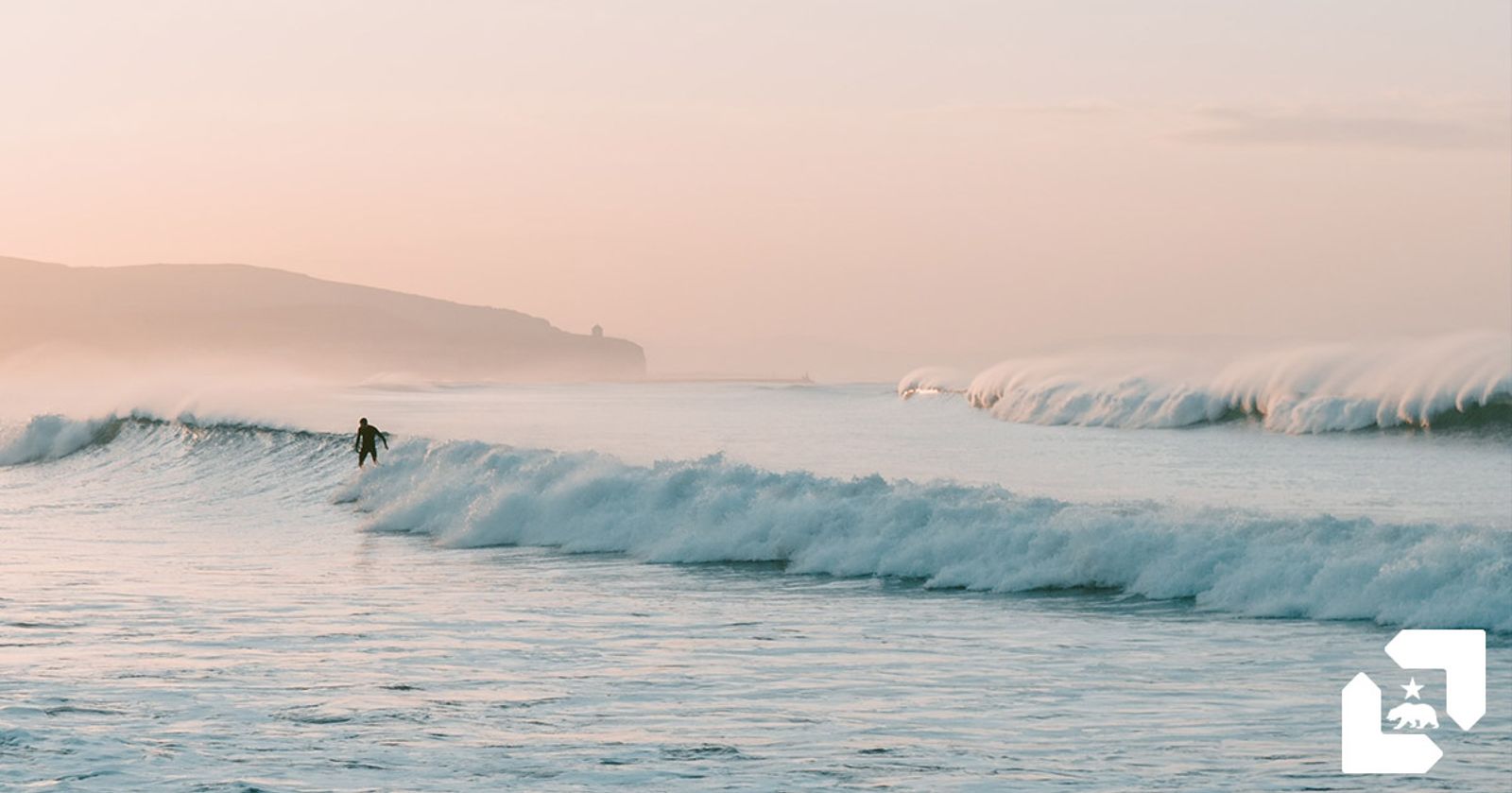 Surfer catching a wave at sunset
