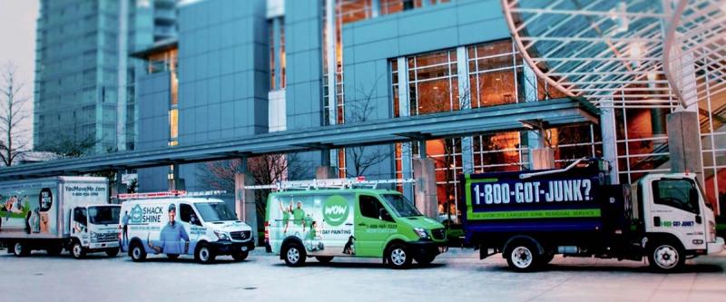 A lineup of O2E Brands service vehicles including 1-800-GOT-JUNK?, WOW 1 Day Painting and Shack Shine