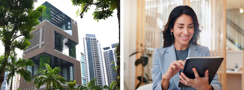 Modern building surrounded by greenery beside a businesswoman using a tablet in an office