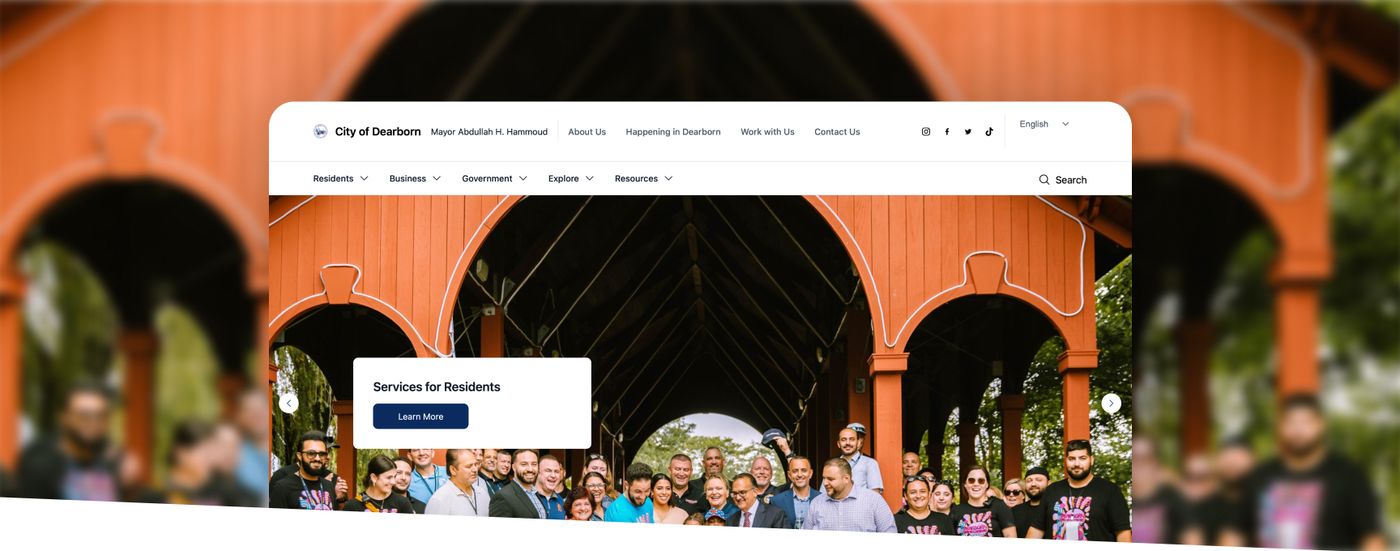 City of Dearborn website homepage overlaid on a photo of residents gathered under a covered walkway