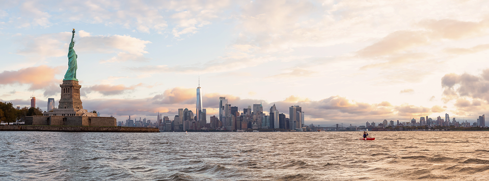 Statue of Liberty and the Lower Manhattan skyline at dusk