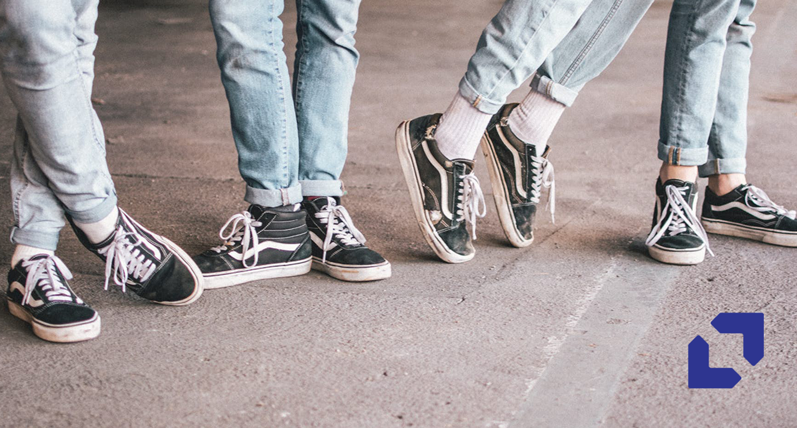 Four people wearing near-identical jeans and sneakers