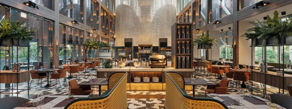 Elegant hotel restaurant and lounge interior with dining tables and a bar