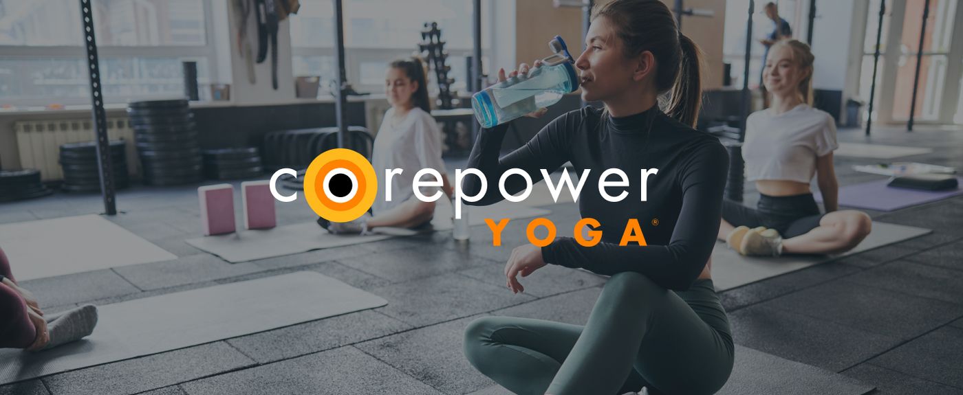 CorePower Yoga studio members stretching and hydrating between poses