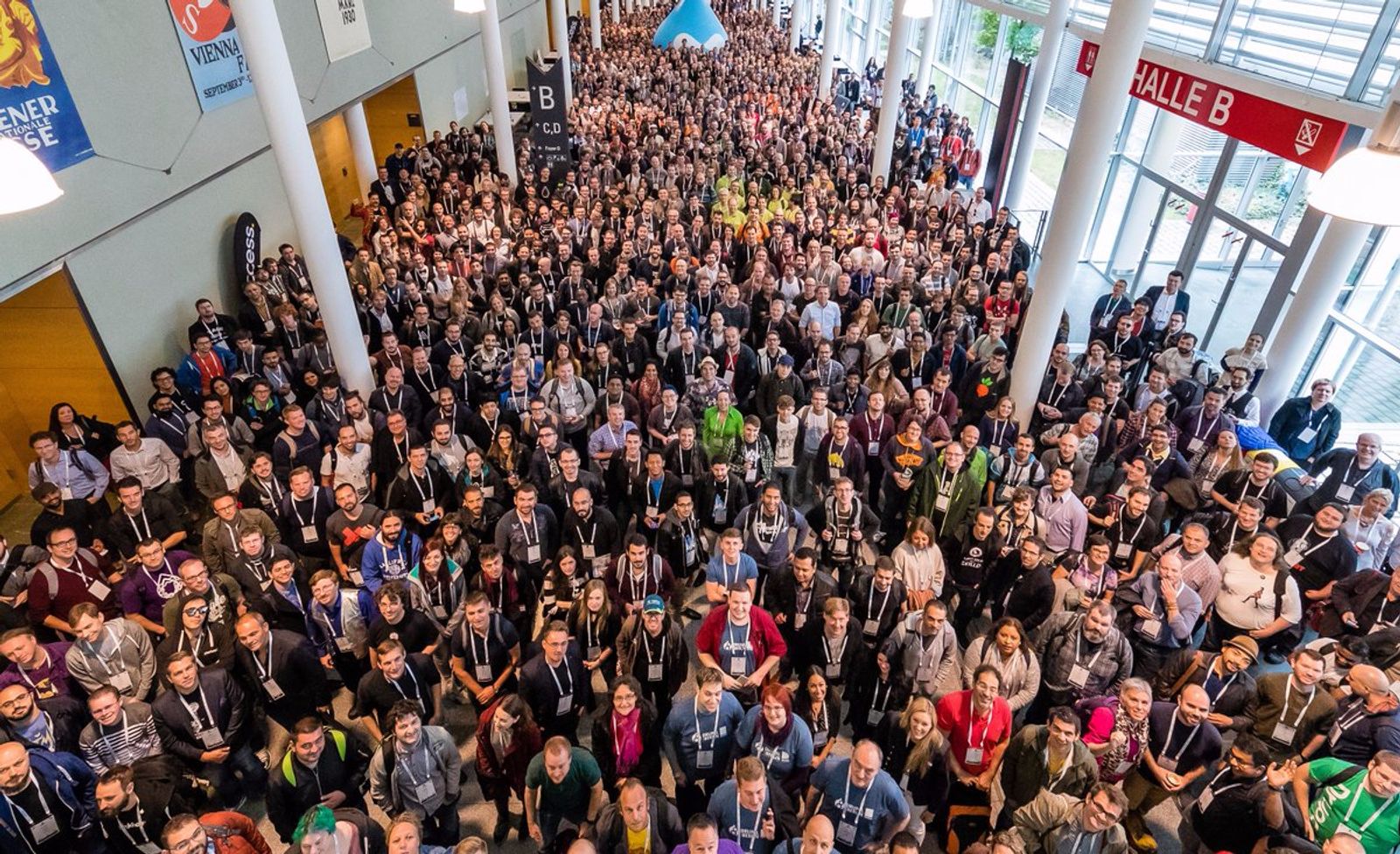 Aerial view of a massive crowd of DrupalCon Vienna attendees filling a convention hall corridor