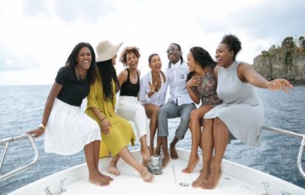 Black travel group cruising on a boat at sea