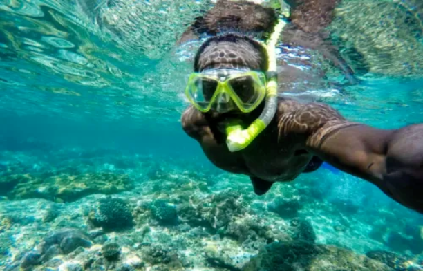 Black traveller scuba diving