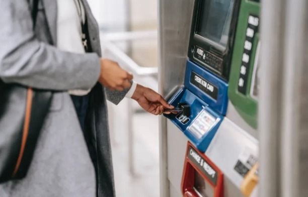 A person inserting a credit card into a card machine
