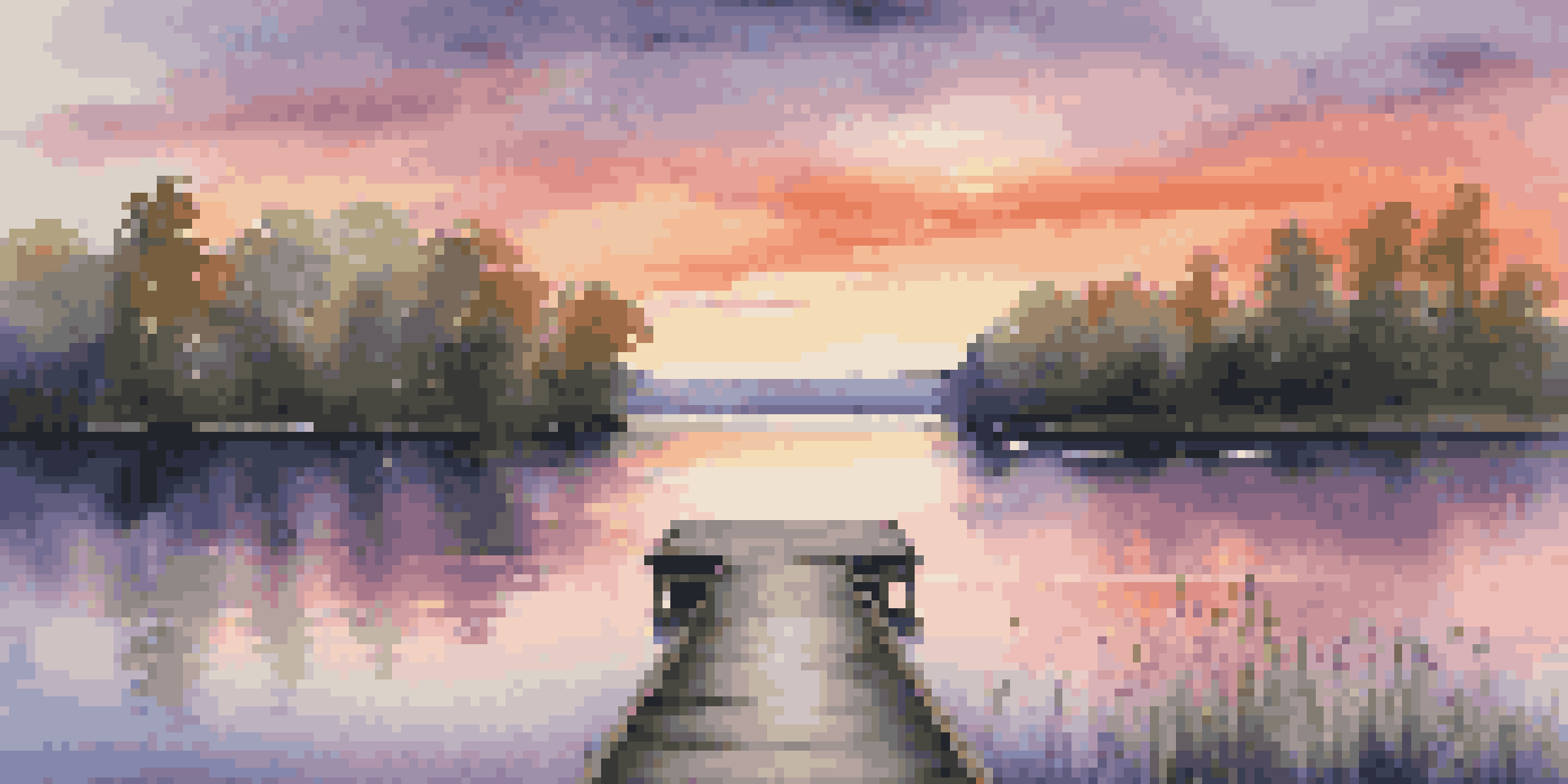 A tranquil lake at sunset with vibrant colors in the sky and a wooden dock in the foreground.