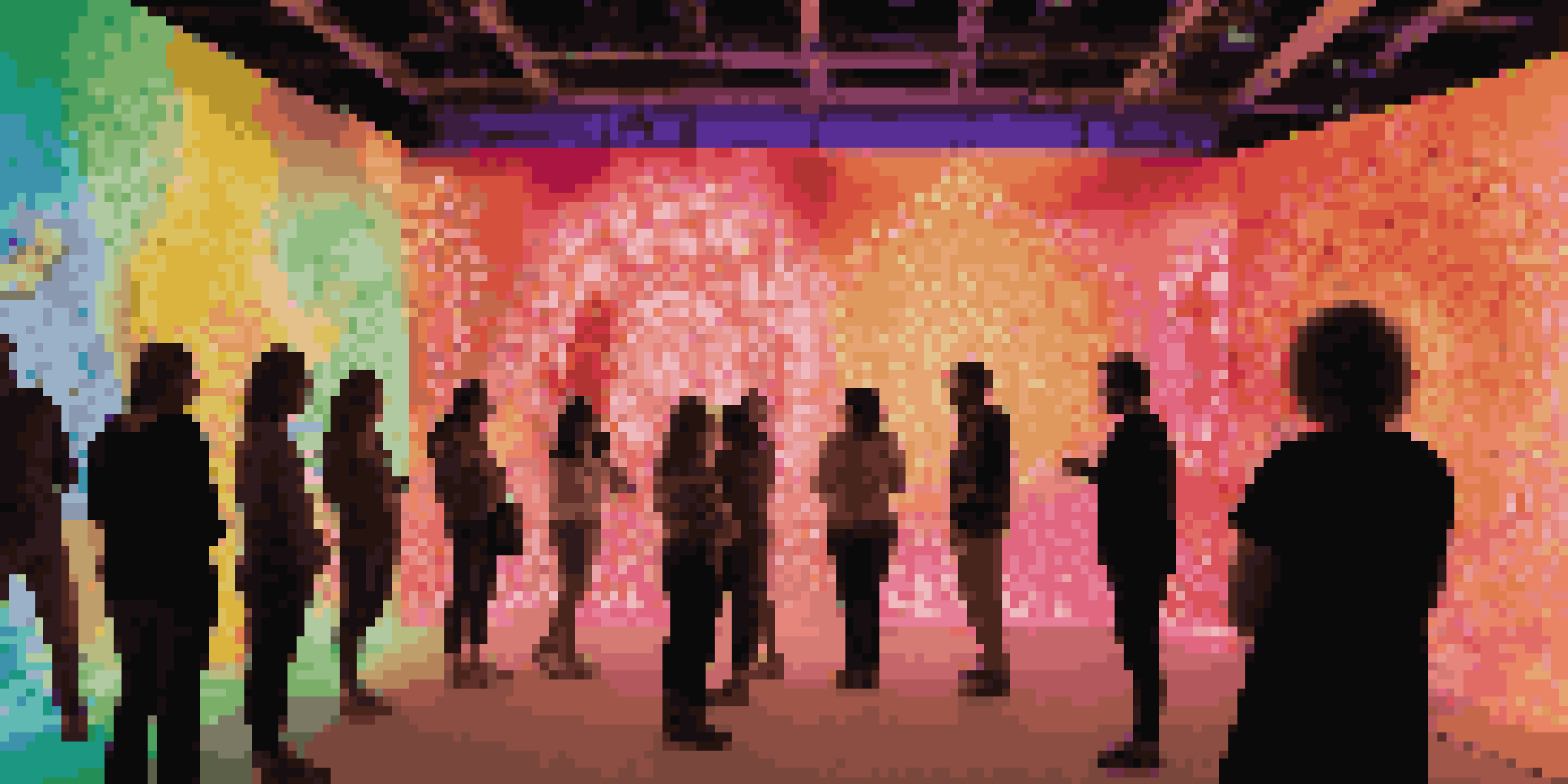 An immersive art installation filled with colorful light projections and people interacting with the display.