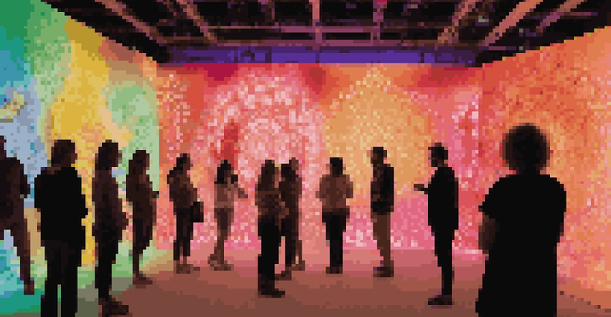 An immersive art installation filled with colorful light projections and people interacting with the display.