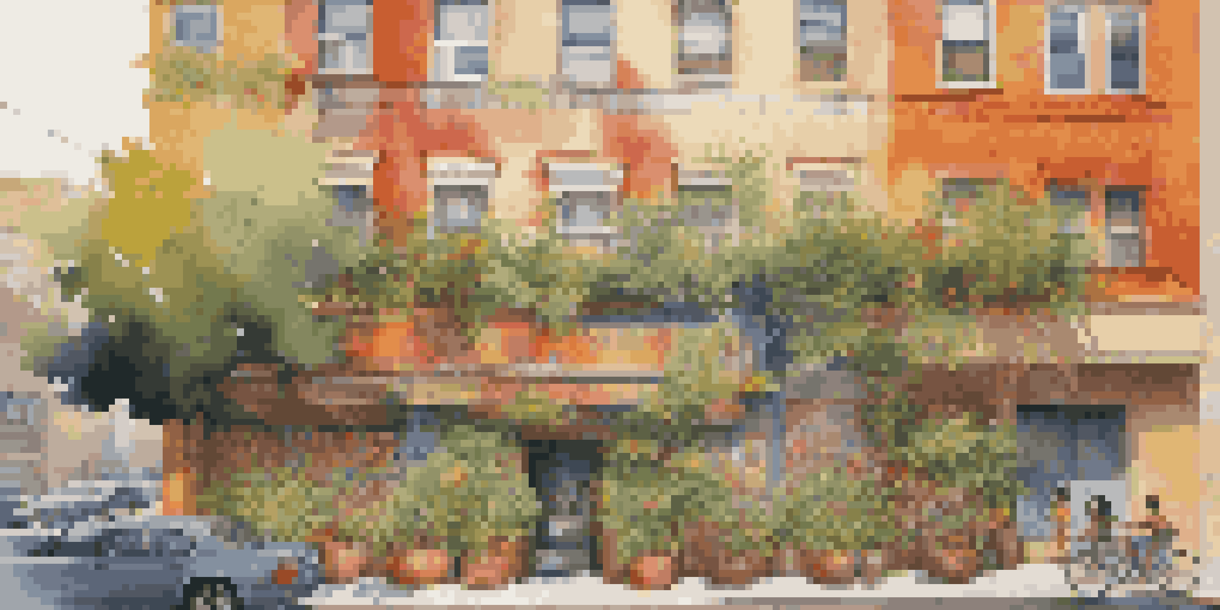 A colorful mural on an apartment building, surrounded by greenery and illuminated by warm sunlight.