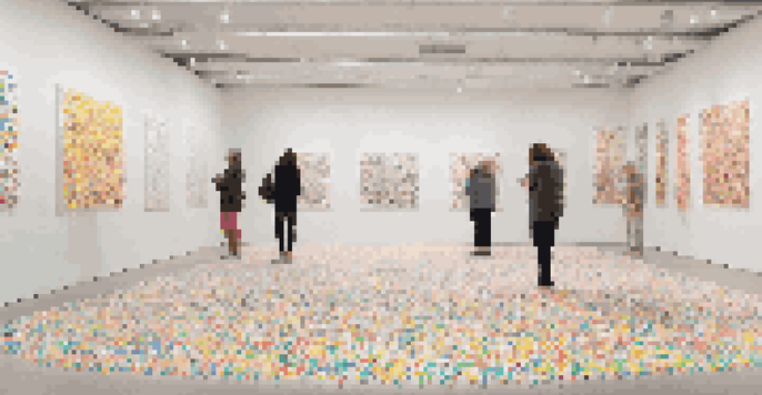 A bright and colorful art installation where a white room is covered in various colored dot stickers, inviting participation and creativity.