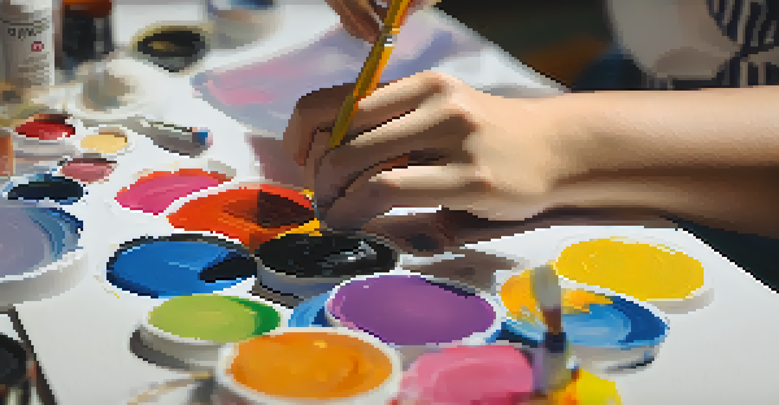 Close-up of a student's hands applying bright colors to a canvas, with scattered art supplies in the background.