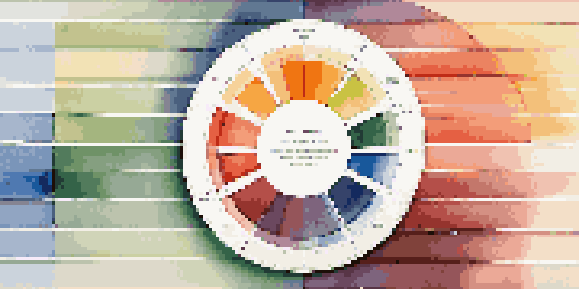 A colorful pie chart displaying the color wheel on a wooden table with soft natural lighting.