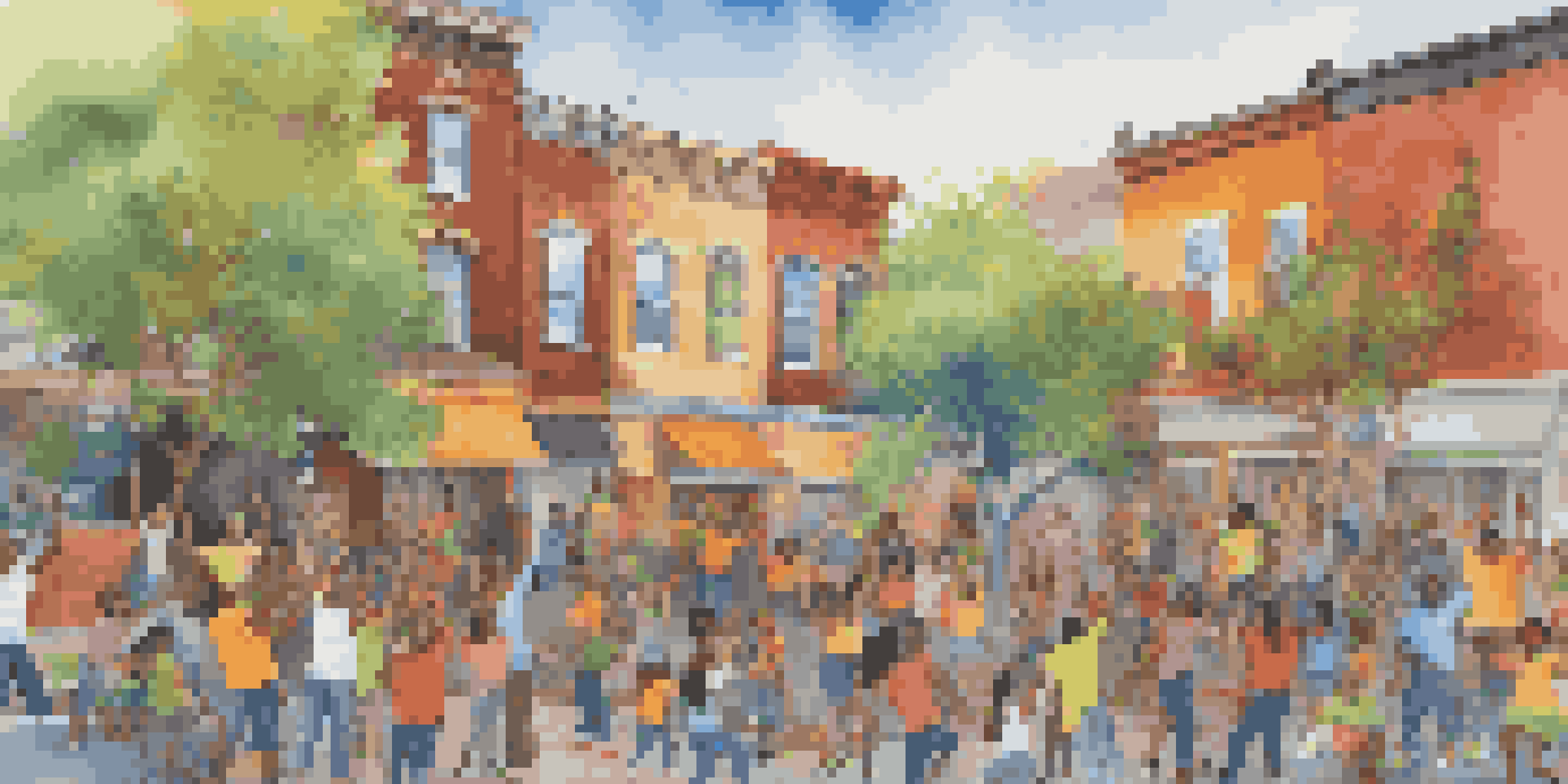 A diverse group of people painting a colorful mural together on a wall, showcasing collaboration and creativity.
