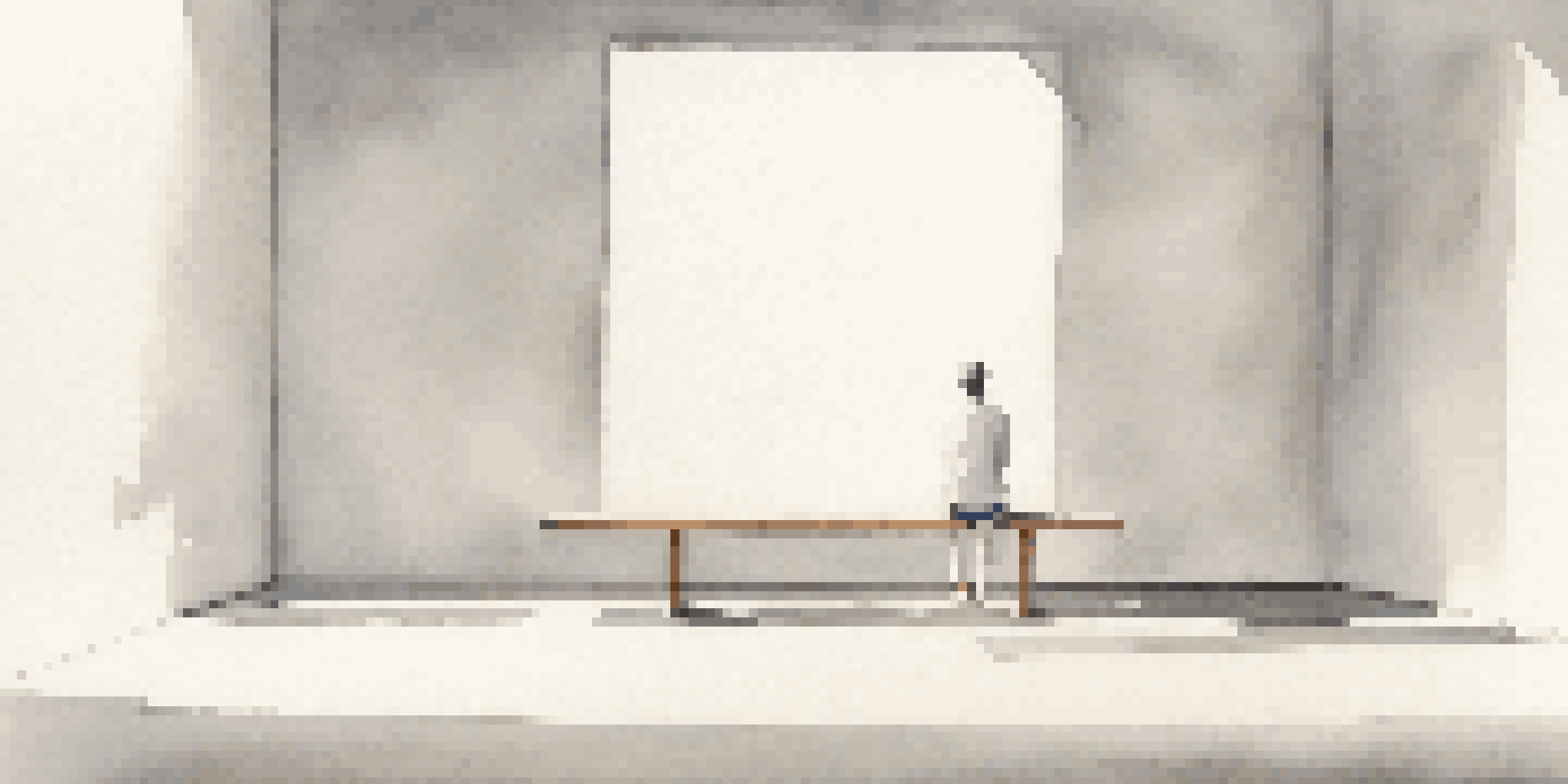 A minimalist art installation with white walls and a solitary bench, emphasizing silence and reflection.
