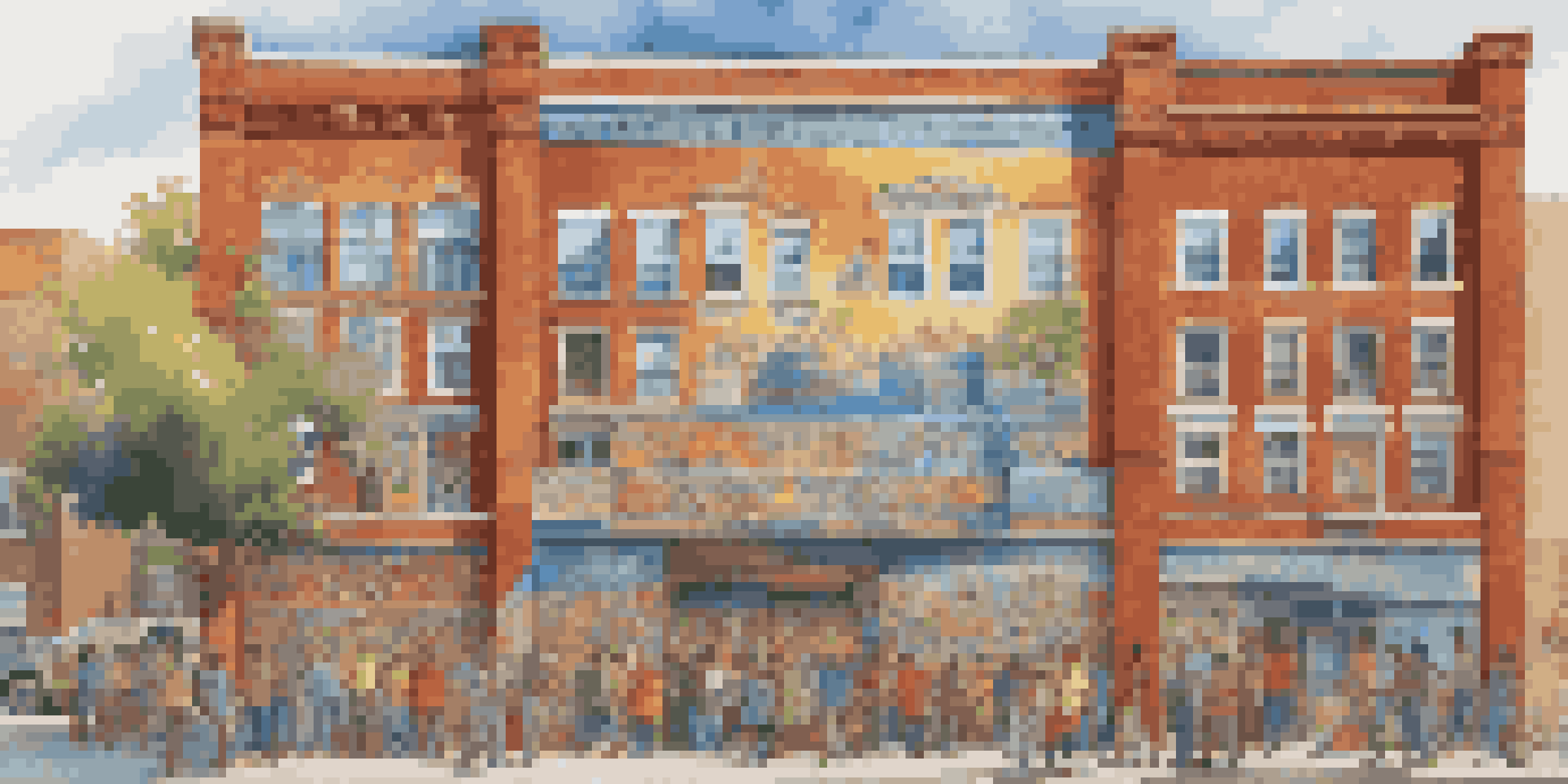 A colorful mural showing a diverse community engaged in activities, with bright colors and intricate details on a brick wall.