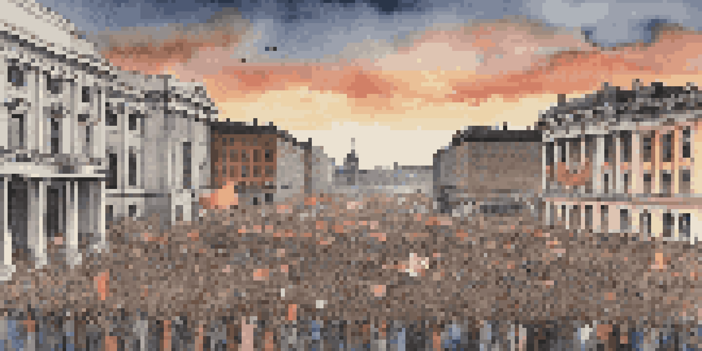 A lively protest scene in a city square with people holding signs, historic buildings, and a sunset sky.