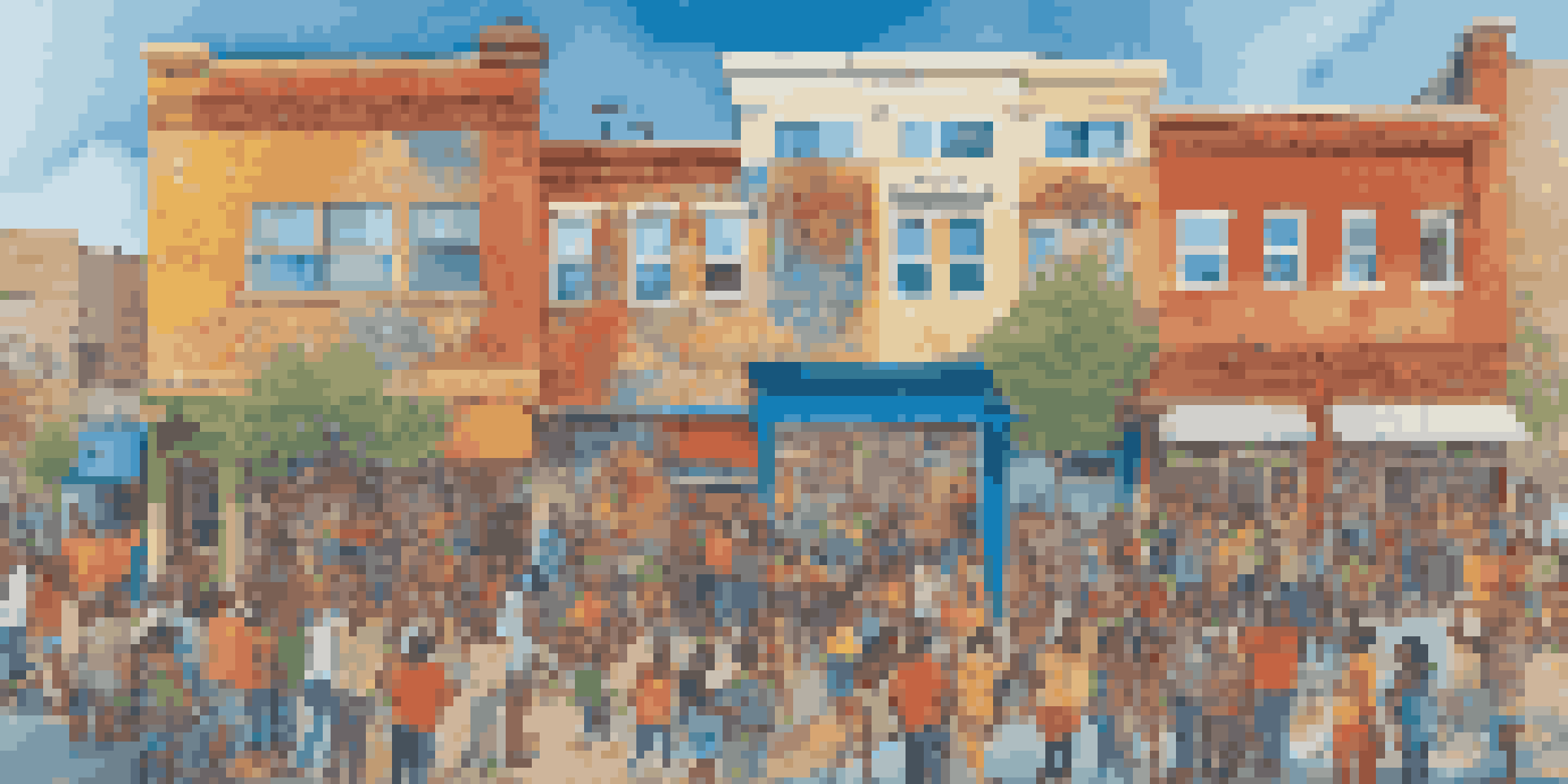 A colorful community mural being painted by residents, showcasing diverse cultural symbols and stories under a clear blue sky.