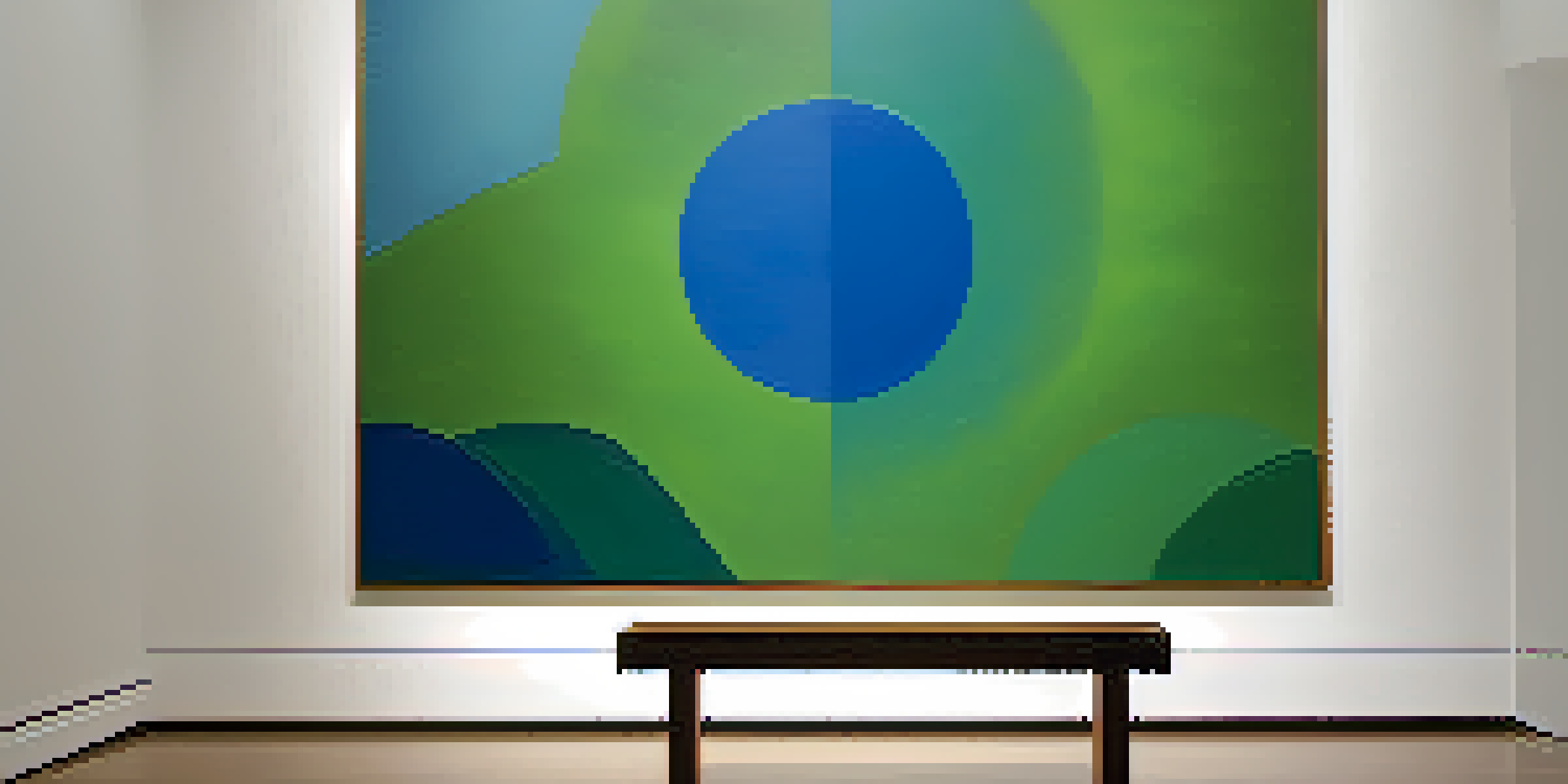 A minimalist art gallery with soft lighting showcasing an abstract painting in blues and greens, and a wooden bench in front.