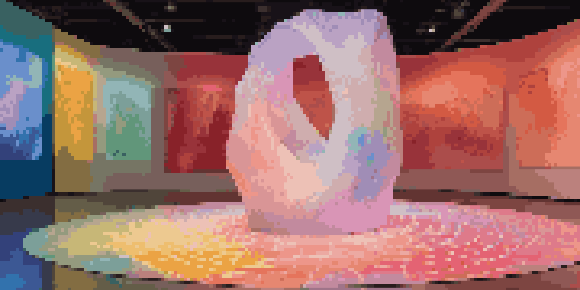 An interactive art installation with a central abstract sculpture, colorful lights, and soft textured flooring inviting viewer engagement.