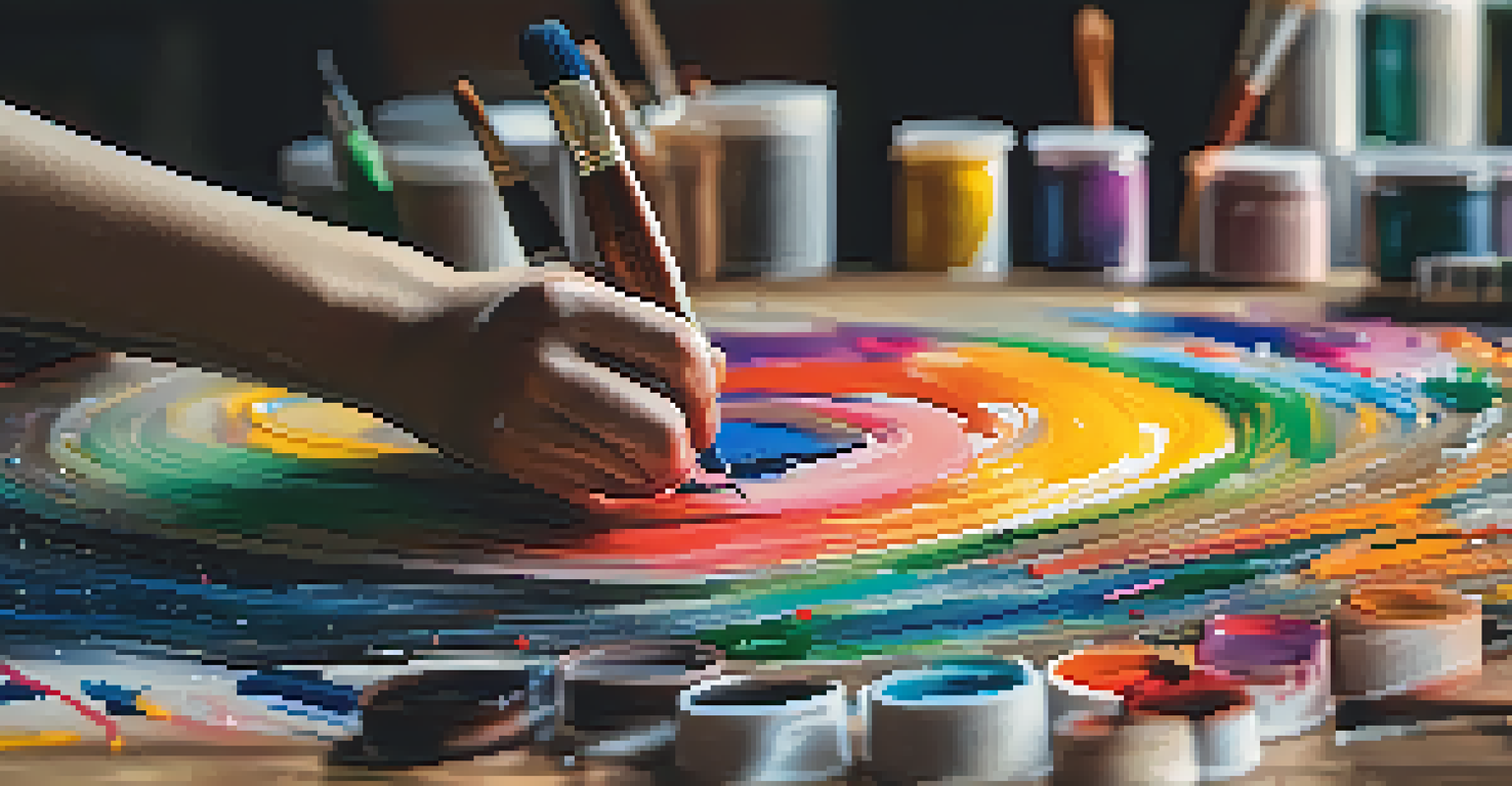 An artist's hand painting on a canvas surrounded by colorful paint tubes and brushes.
