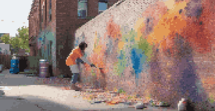 A young artist painting a colorful street art mural on a brick wall, with paint cans scattered around and sunlight casting shadows.