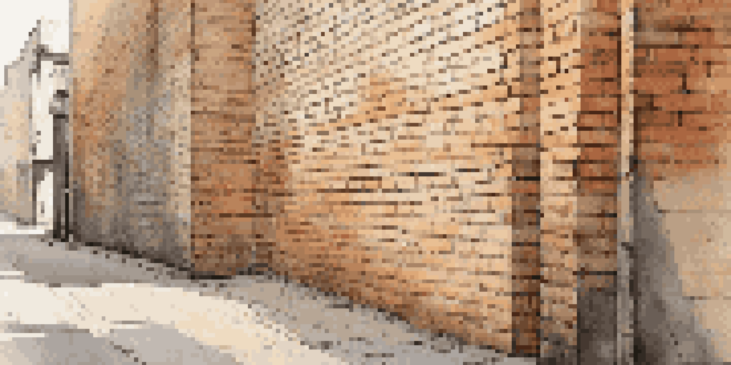 A weathered brick wall with a single bold line drawn across it, illuminated by soft sunlight, highlighting the contrast between the artwork and the wall's texture.
