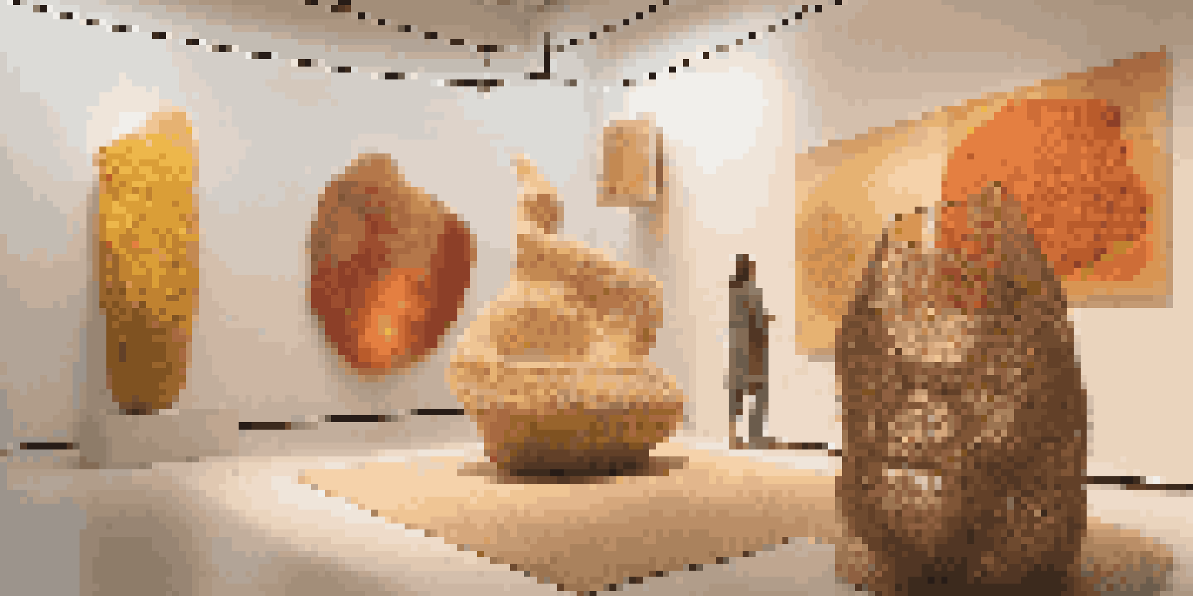 A gallery filled with sculptures made from biodegradable materials, illuminated by soft natural light, showcasing earthy colors and textures.