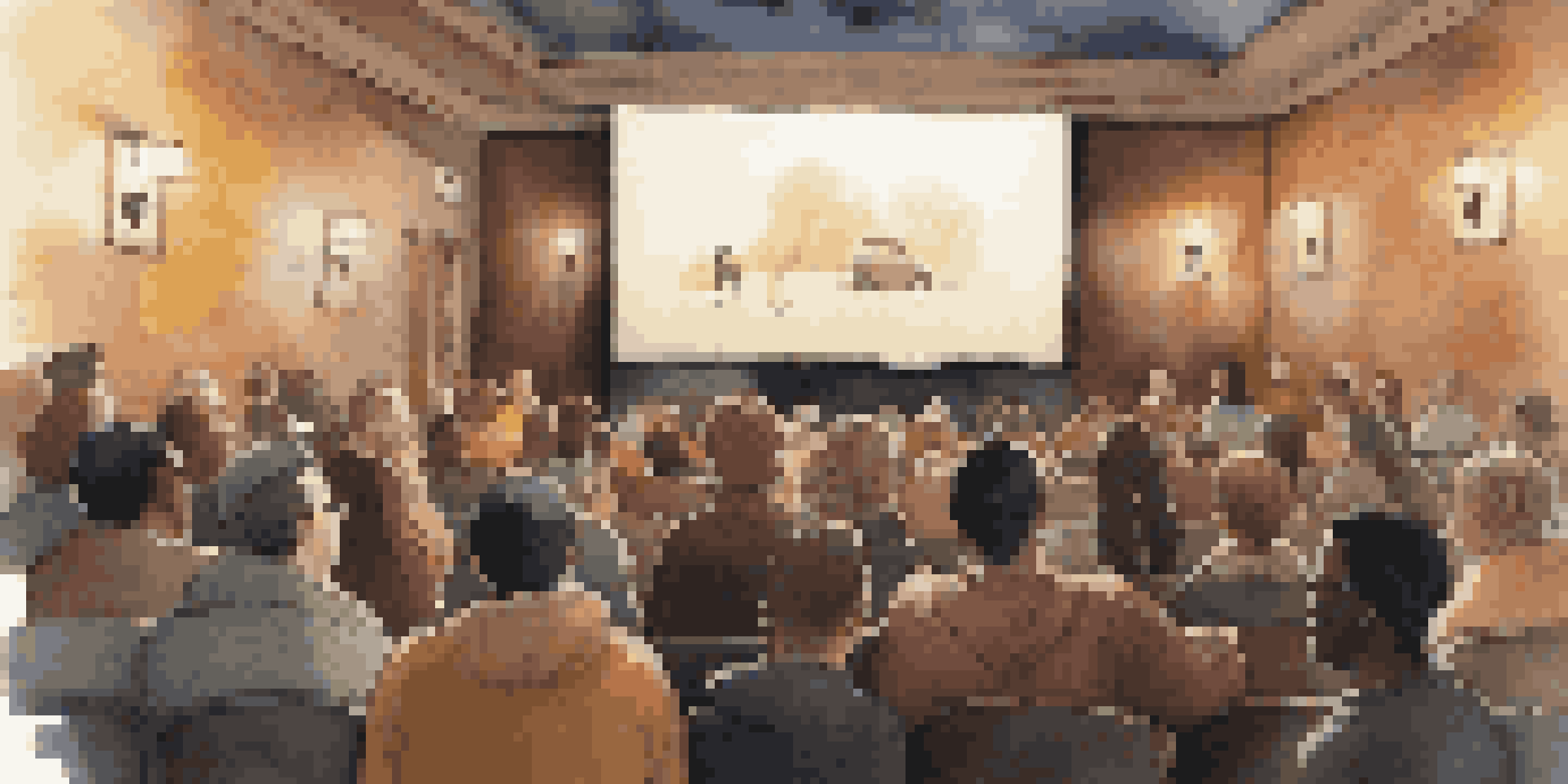 A cozy documentary film screening room with an engaged audience laughing at a humorous scene.