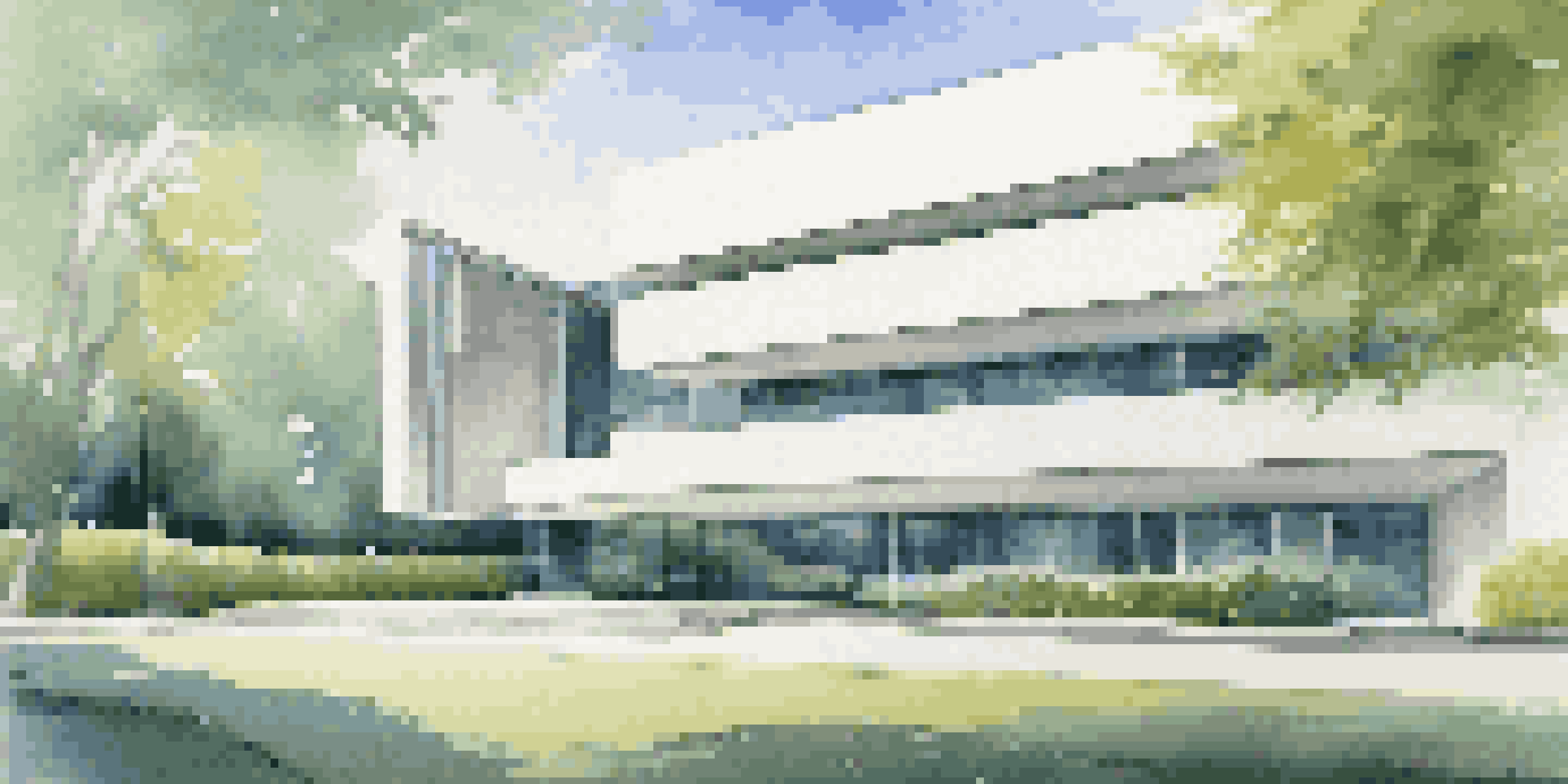 A modernist building with a minimalist design, surrounded by greenery and blue sky, featuring large glass windows and a concrete exterior.