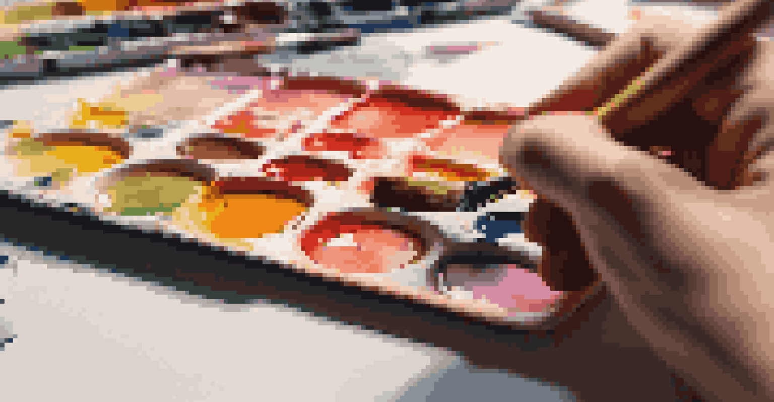 A close-up of a hand with a paintbrush over a colorful palette, with a canvas in the background under soft lighting.