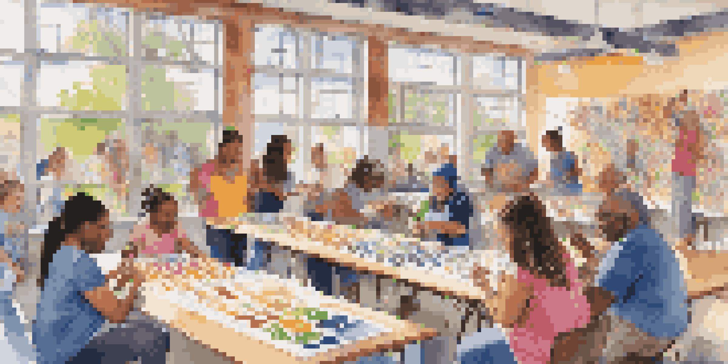 A lively community art space with diverse people of different ages and backgrounds painting a mural together, surrounded by colorful art supplies and bathed in natural sunlight.