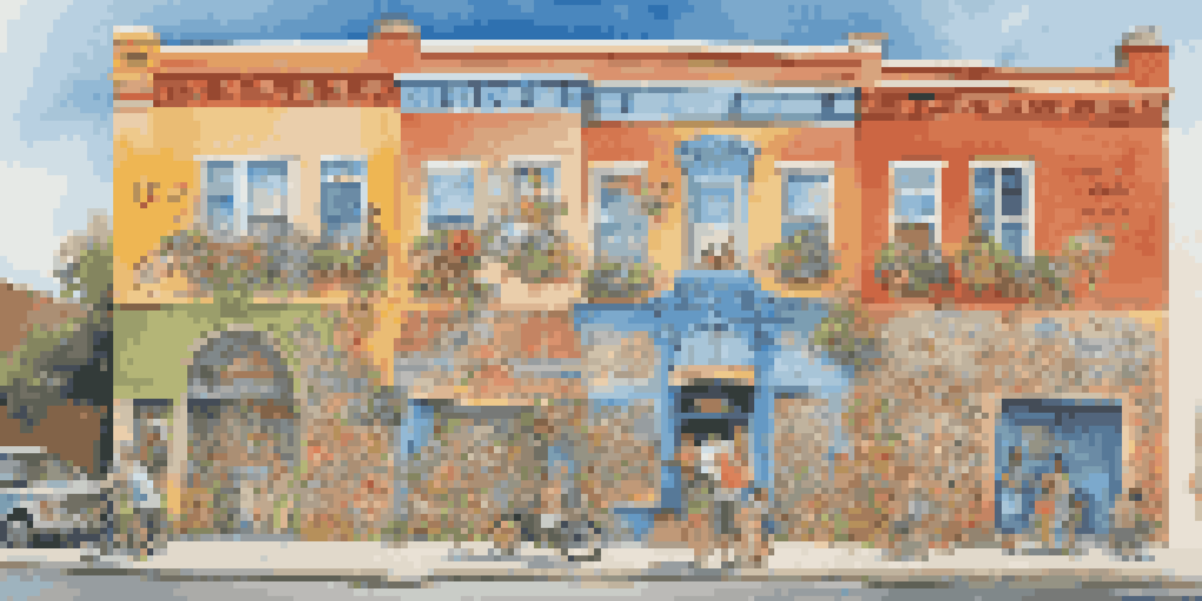 A colorful community mural with whimsical characters and humorous phrases, painted on a building's wall.