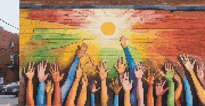 A colorful mural of diverse hands raised together in solidarity, located on a city wall, with sunlight illuminating the scene.