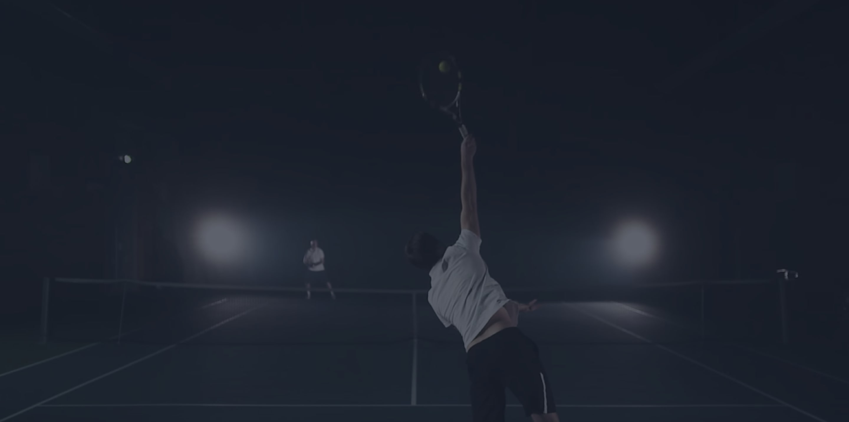 Two persons playing tennis. 