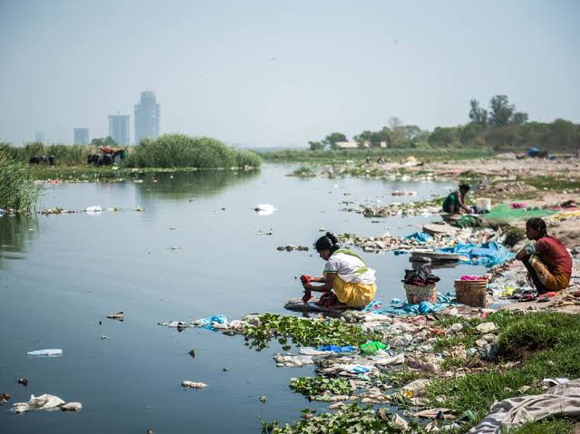 women washing in dirty Water-Common Sicknesses During Rainy Season
