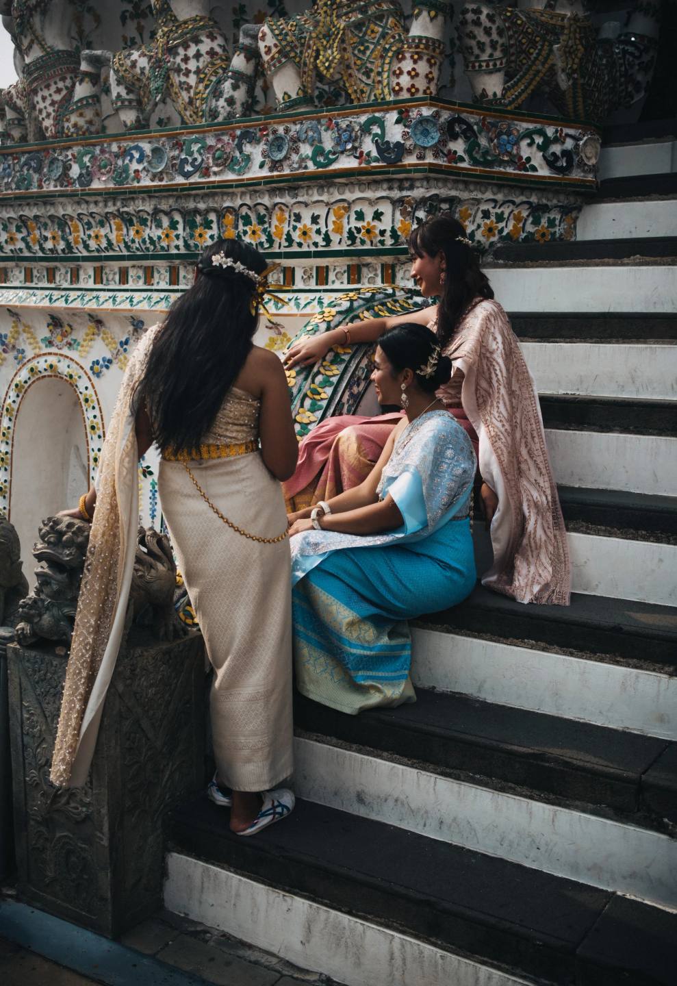 Visitors beside an ornate tiled temple facade.