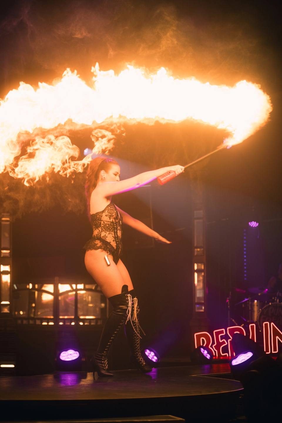 Female performer using a fire torch