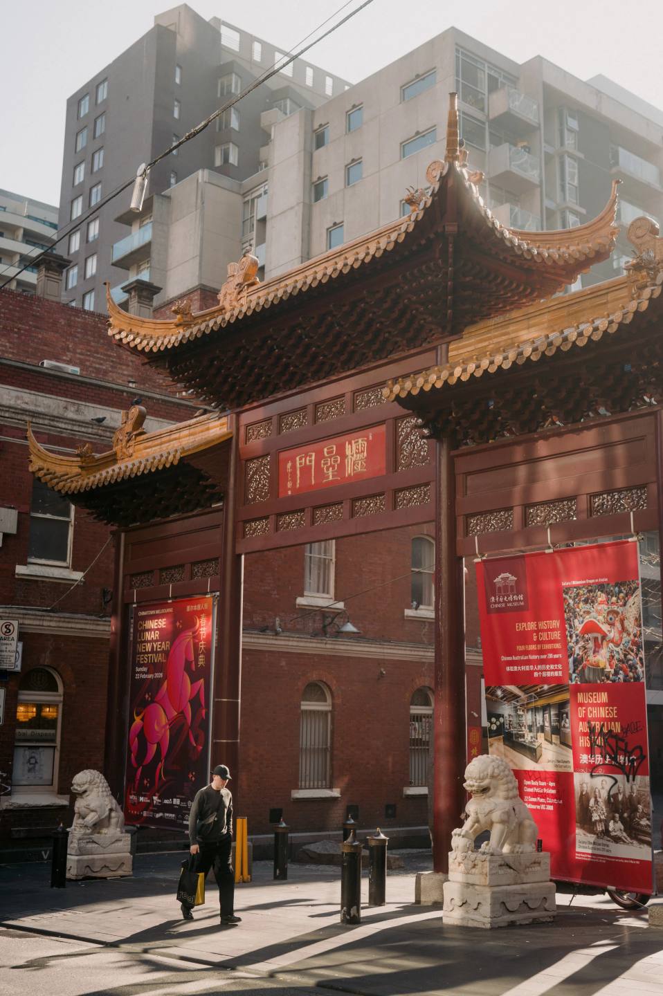 A red gateway between the buildings of Chinatown.