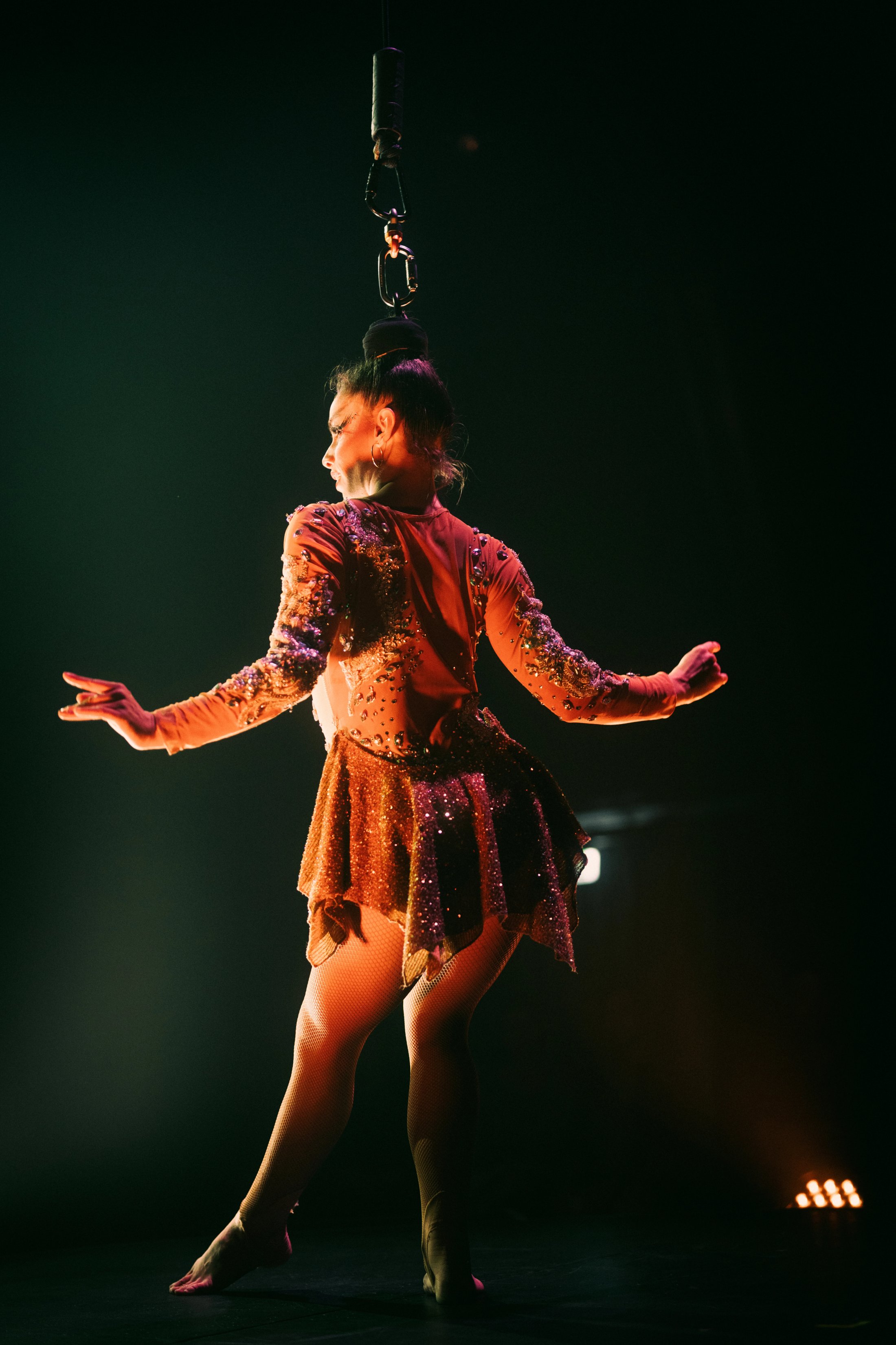 Female dancer held up by her hair