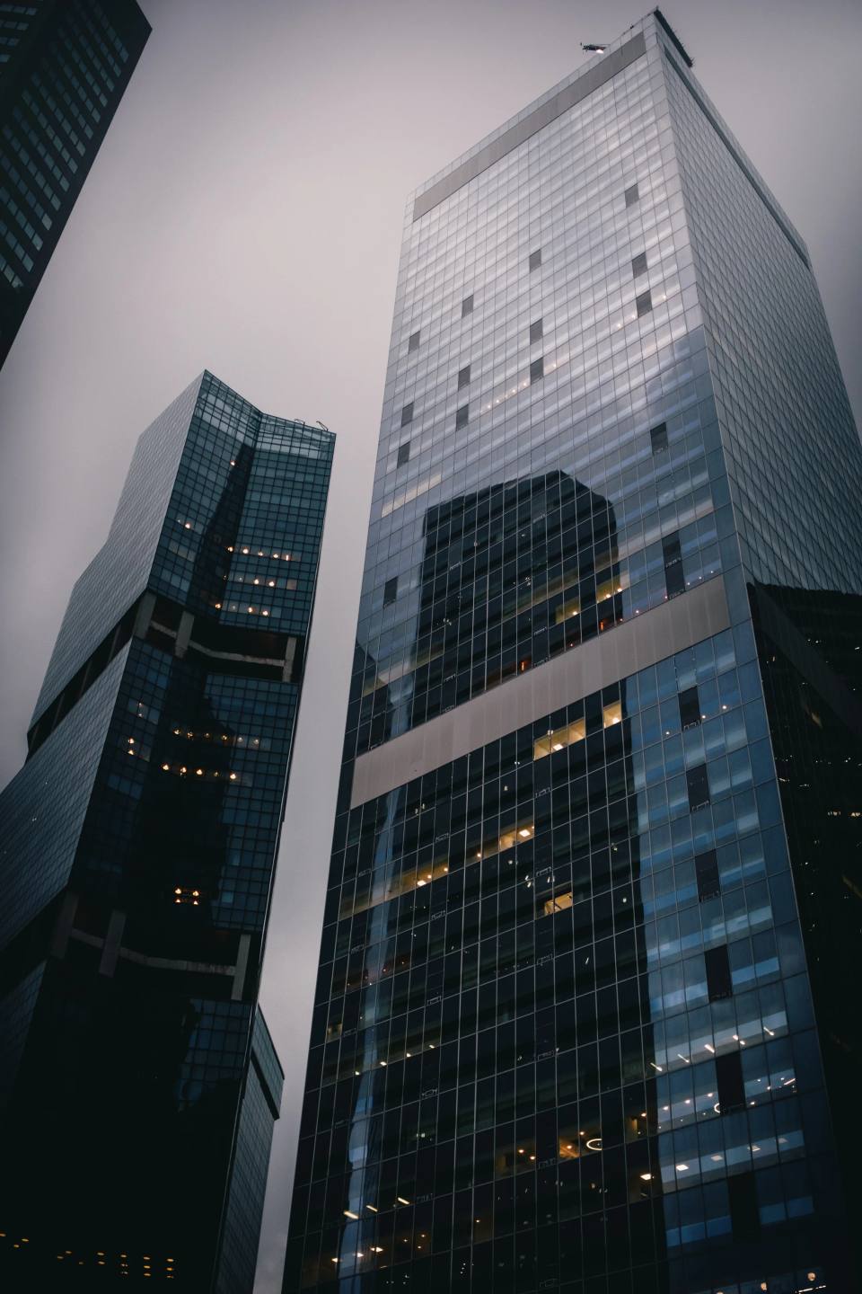 Tall office towers viewed from street level.