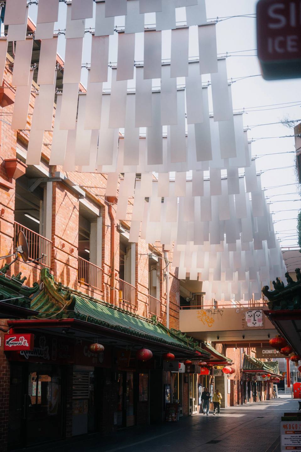 Warm brick buildings and a bright sculptural canopy.