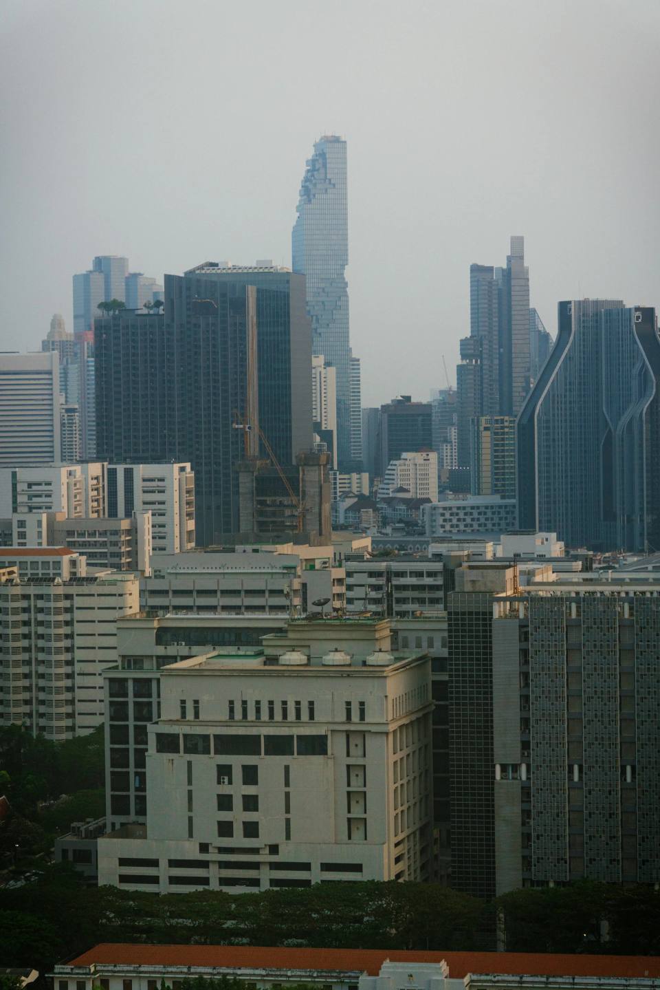 Layers of towers across a hazy urban skyline.