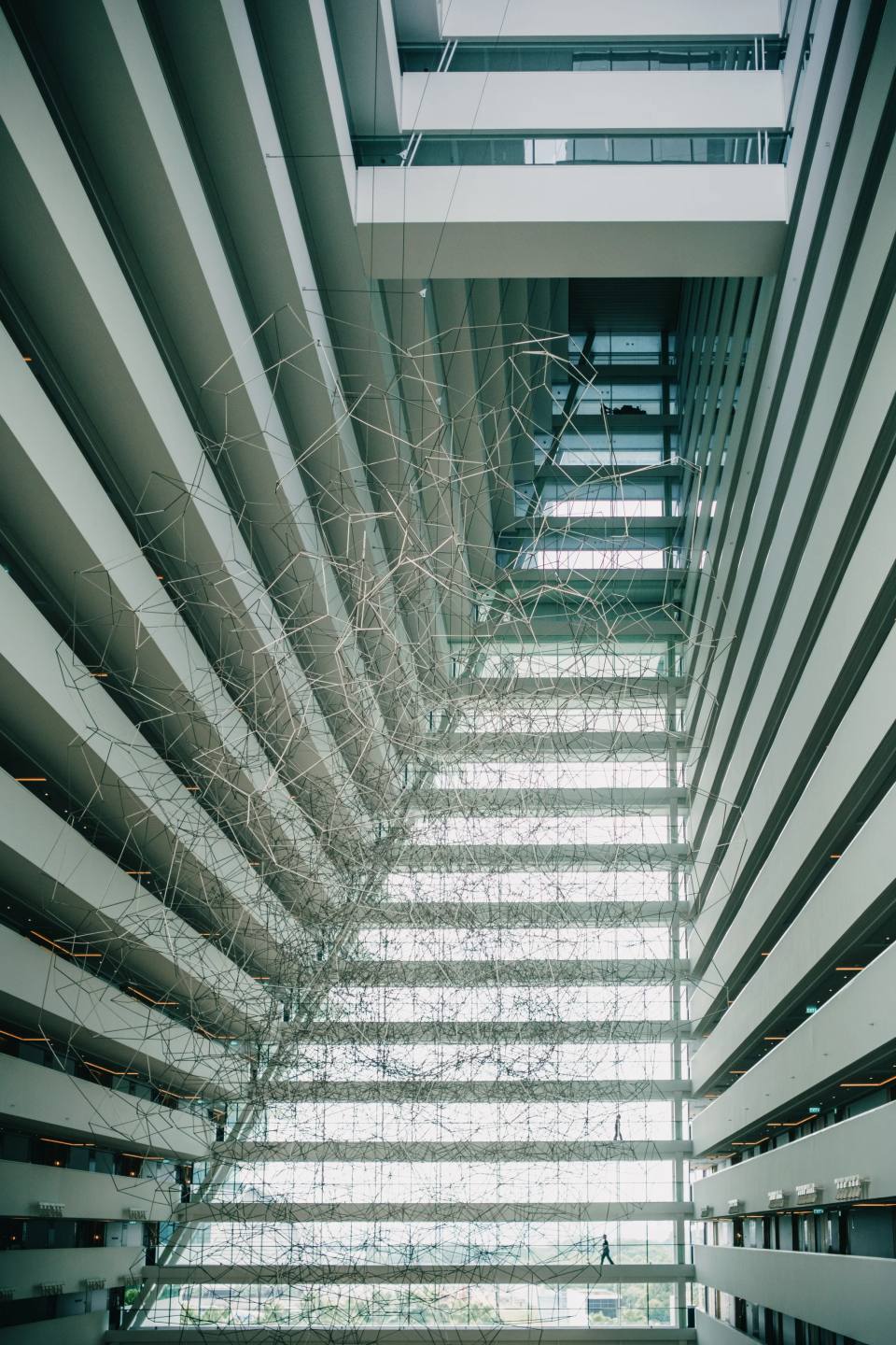Repeating balconies looking up through a tall atrium.