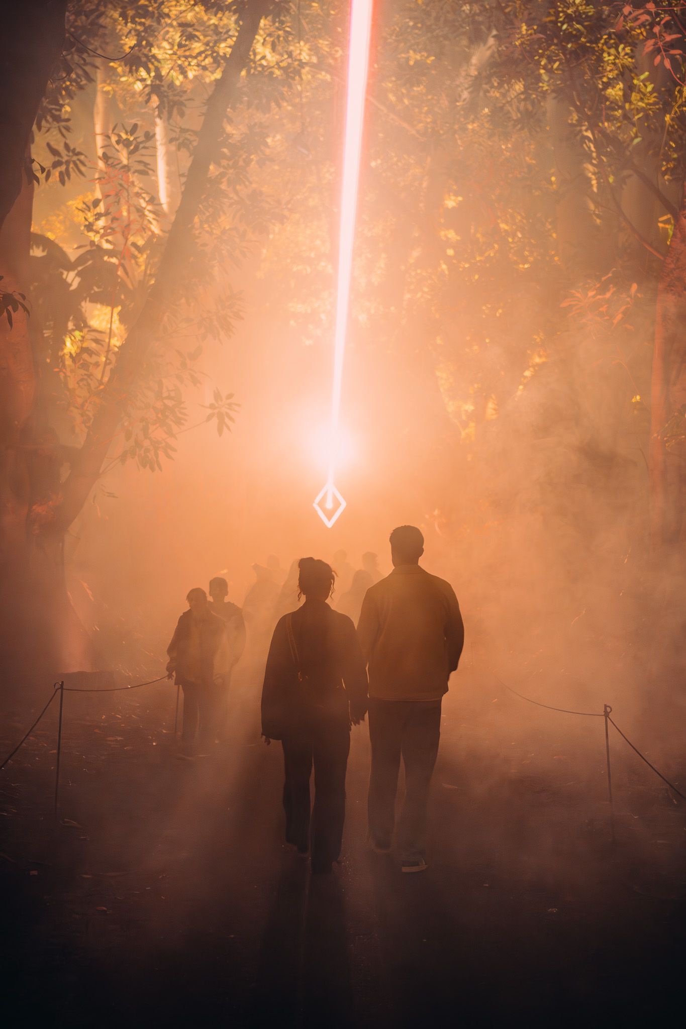 People walking into light beam