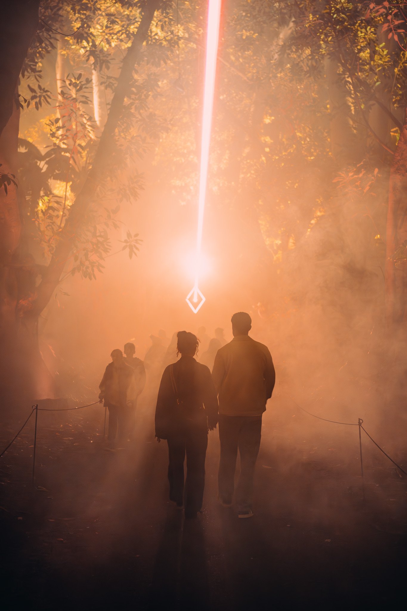 People walking into light beam