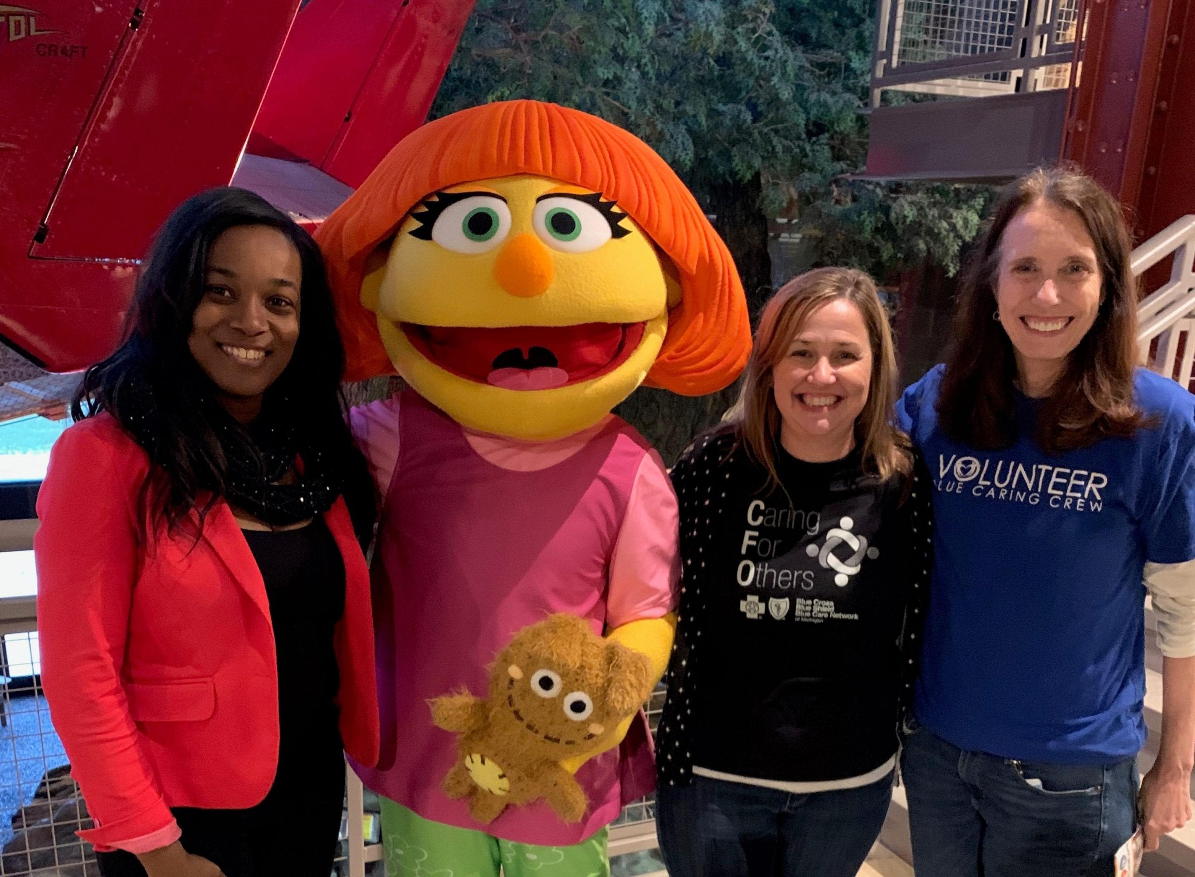 Image of Blue Cross employees posing with Julia at the Outdoor Adventure Center.