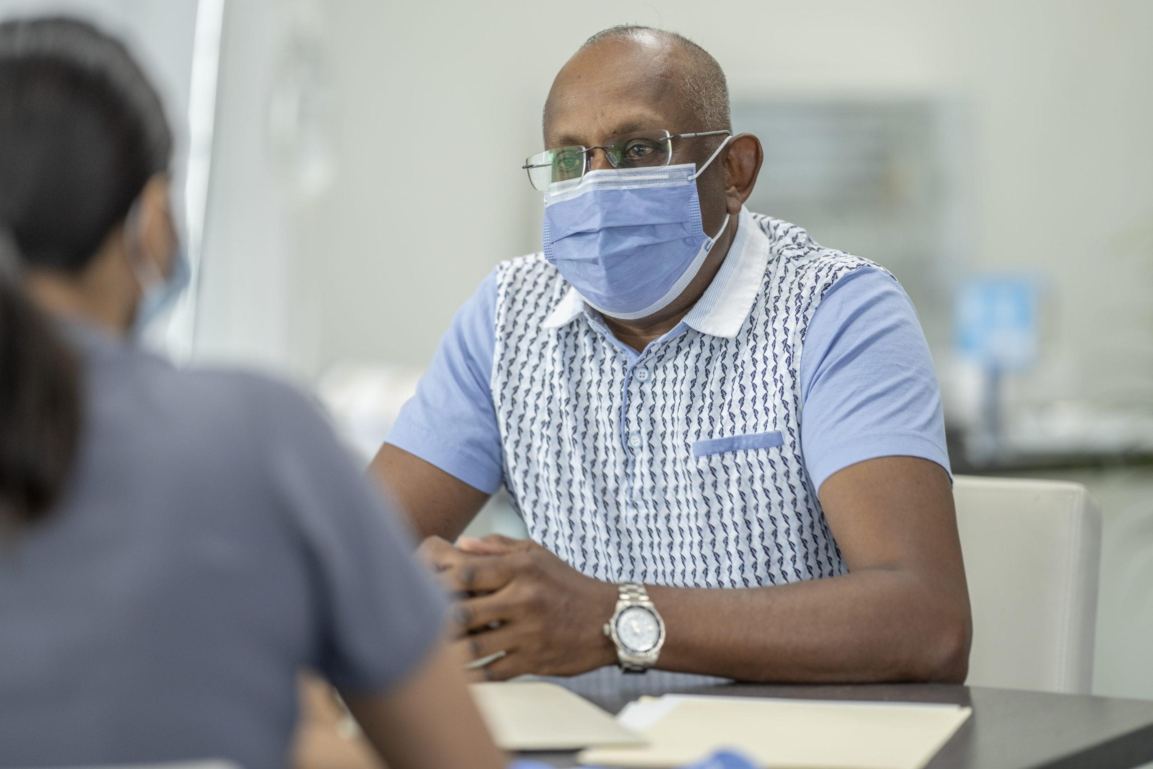 Man talks about colorectal cancer screening with his doctor